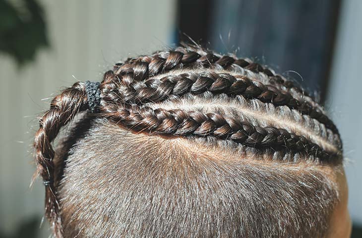 Detalle cabeza hombre trenzas