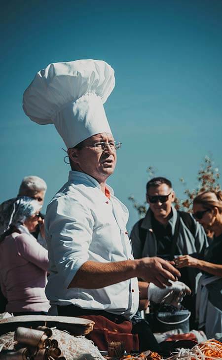 Hombre cocinerode pie cerca comida